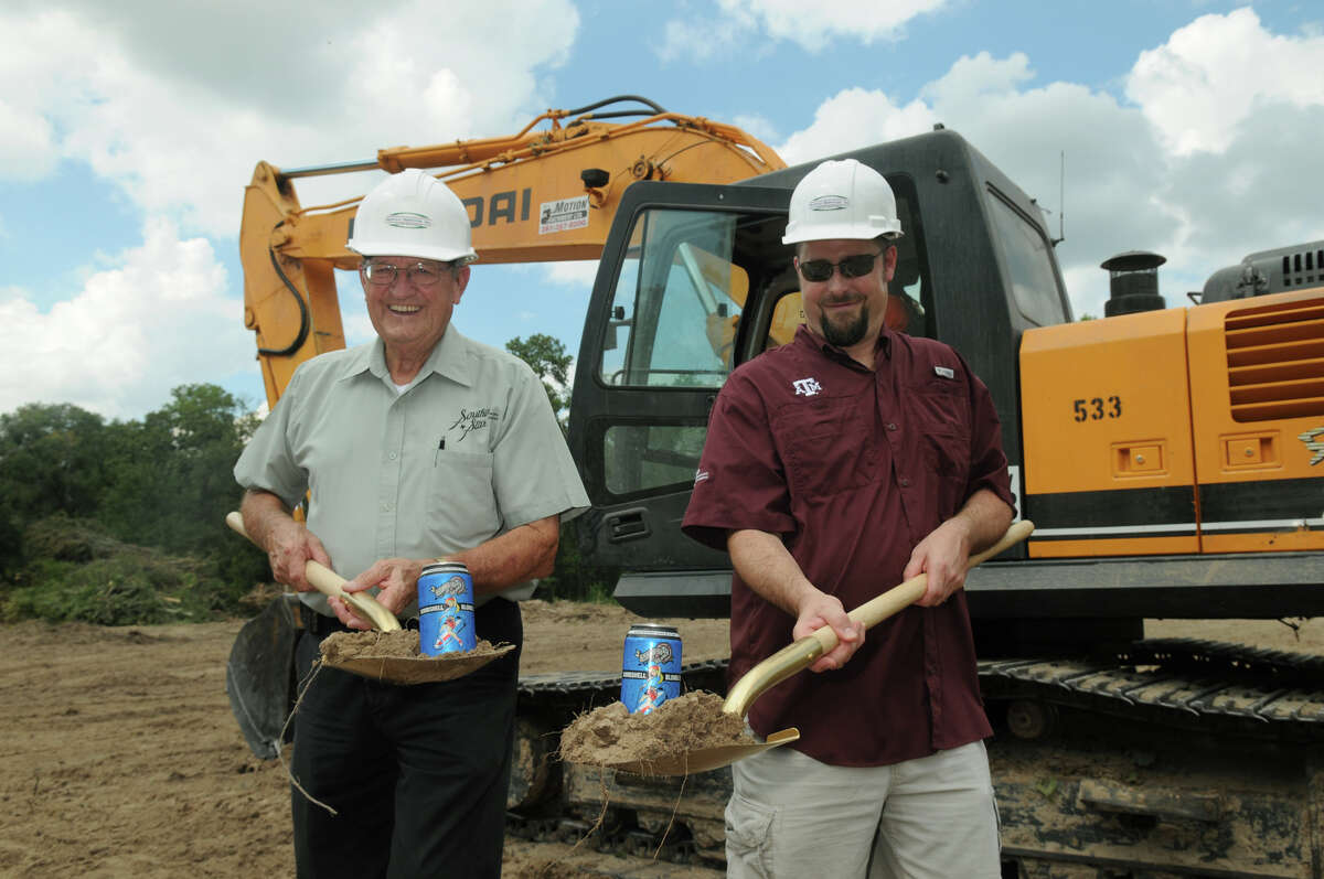 Chuck Fougeron, left, Vice-President of Southern Star Brewing Company, and his son, Dave, President, pose for photos during the groundbreaking ceremony for their brewing facility in Conroe.
