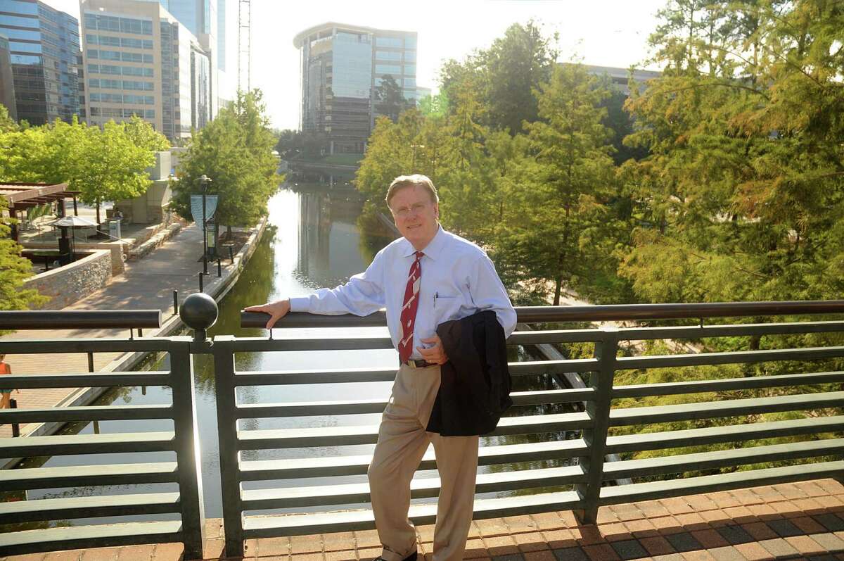 Robert Heineman, vice president of planning for The Woodlands Development Co., stands on the Waterway Avenue bridge over the Woodlands Waterway. Heineman helped design The Woodlands Waterway.