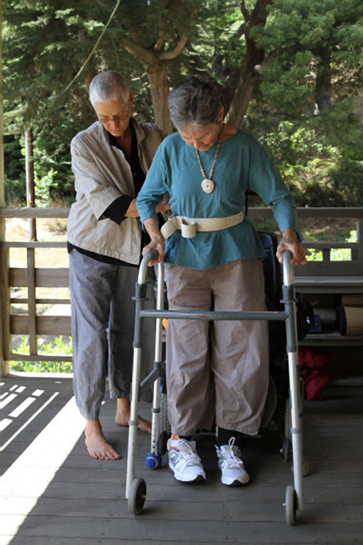 Dr. Grace Dammann performs part of her physical therapy routine with help from partner Fu Schroeder.