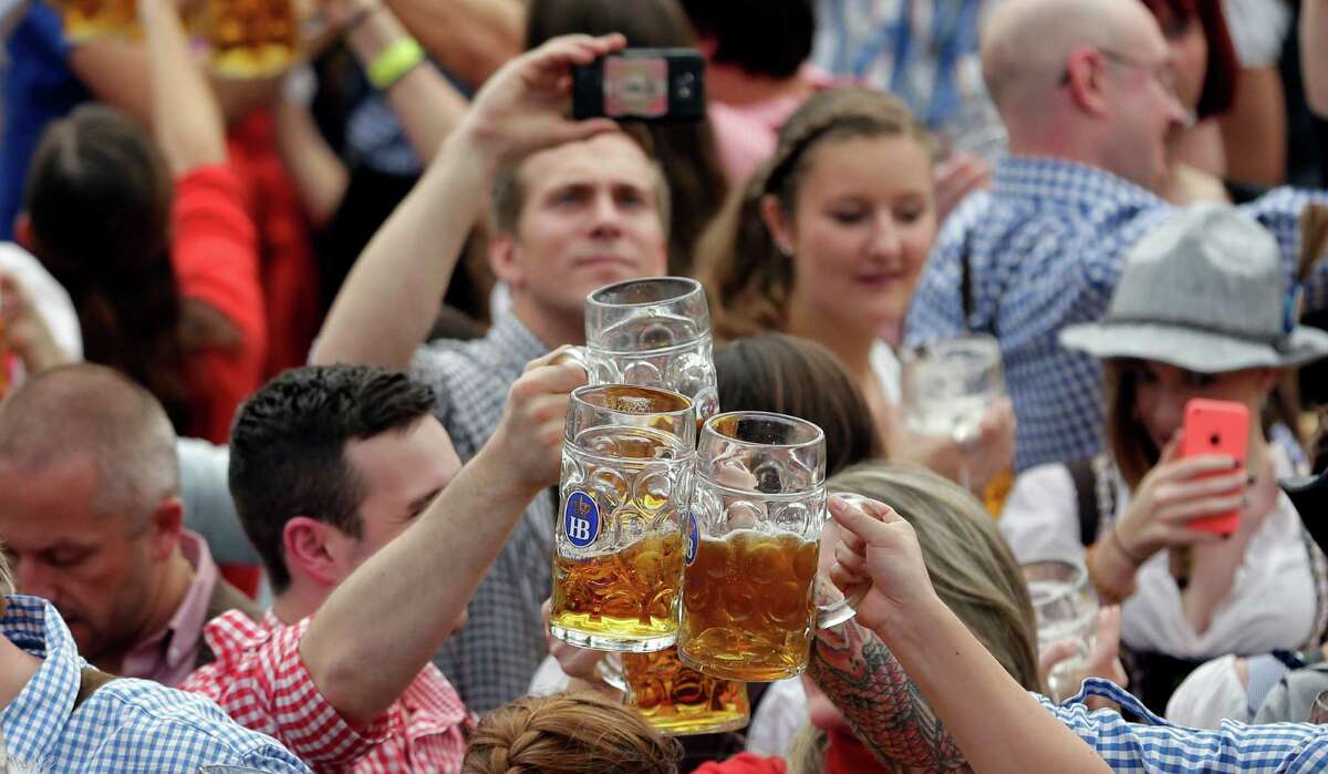 Young people enjoy the second weekend in the 'Hofbraeuhaus beer tent' at the famous beer festival Oktoberfest in Munich, southern Germany, Sunday, Sept. 28, 2014. The world's largest beer festival will be held from Sept. 22 to Oct. 5, 2014. (AP Photo/Matthias Schrader)