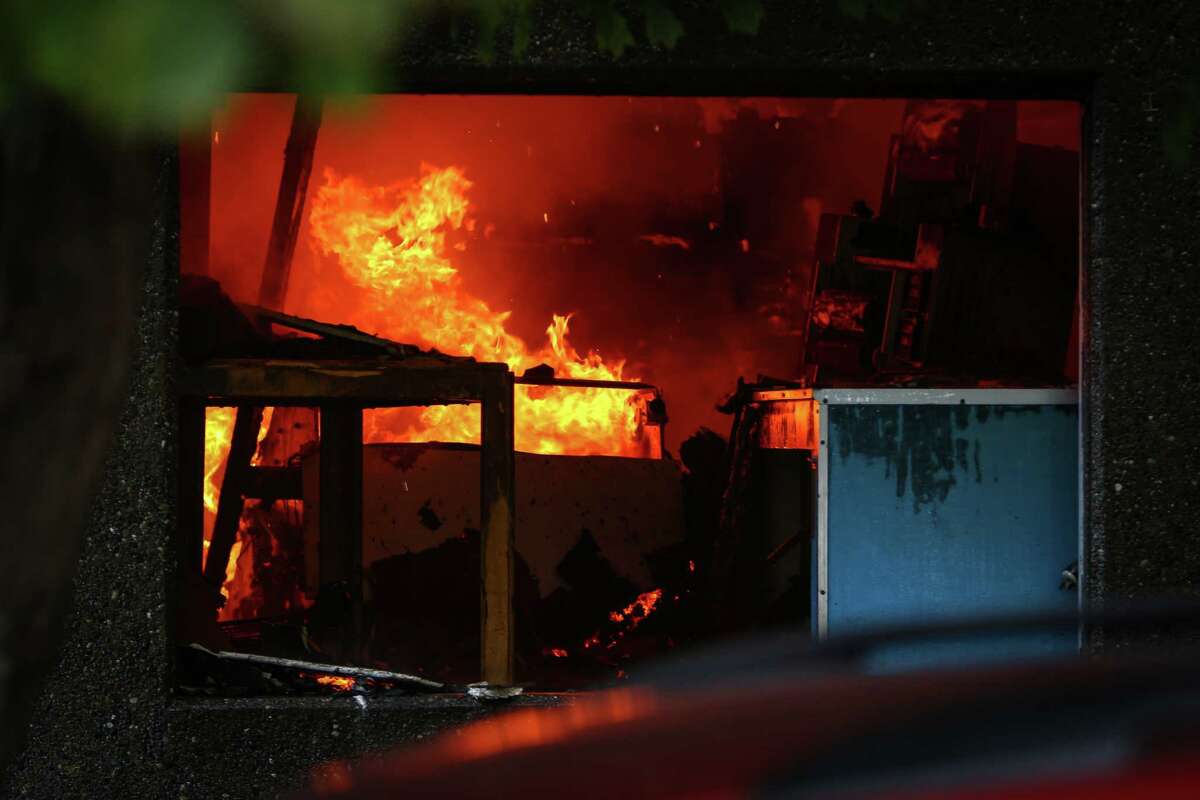 Flames are shown inside of ASKO Processing Inc., a metal-finishing company, in the heart of the Fremont neighborhood on Tuesday, September 30, 2014. The two-alarm fire completely destroyed the business and sent towering flames into the sky.