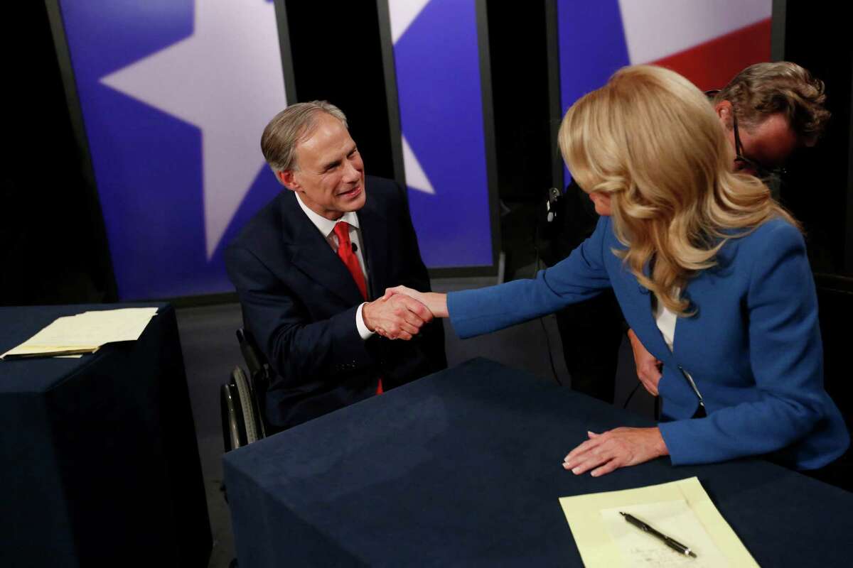 Texas State Senator Wendy Davis, right, Democratic Gubernatorial candidate, and Texas Attorney General Greg Abbott, left, Republican Gubernatorial candidate, shake hands before the final gubernatorial debate in a KERA-TV studio in Dallas on Tuesday Sept. 30, 2014. Ebola, ethics and education were among the issues that dominated the final debate between the two. (AP Photo/The Dallas Morning News, Andy Jacobsohn, Pool)