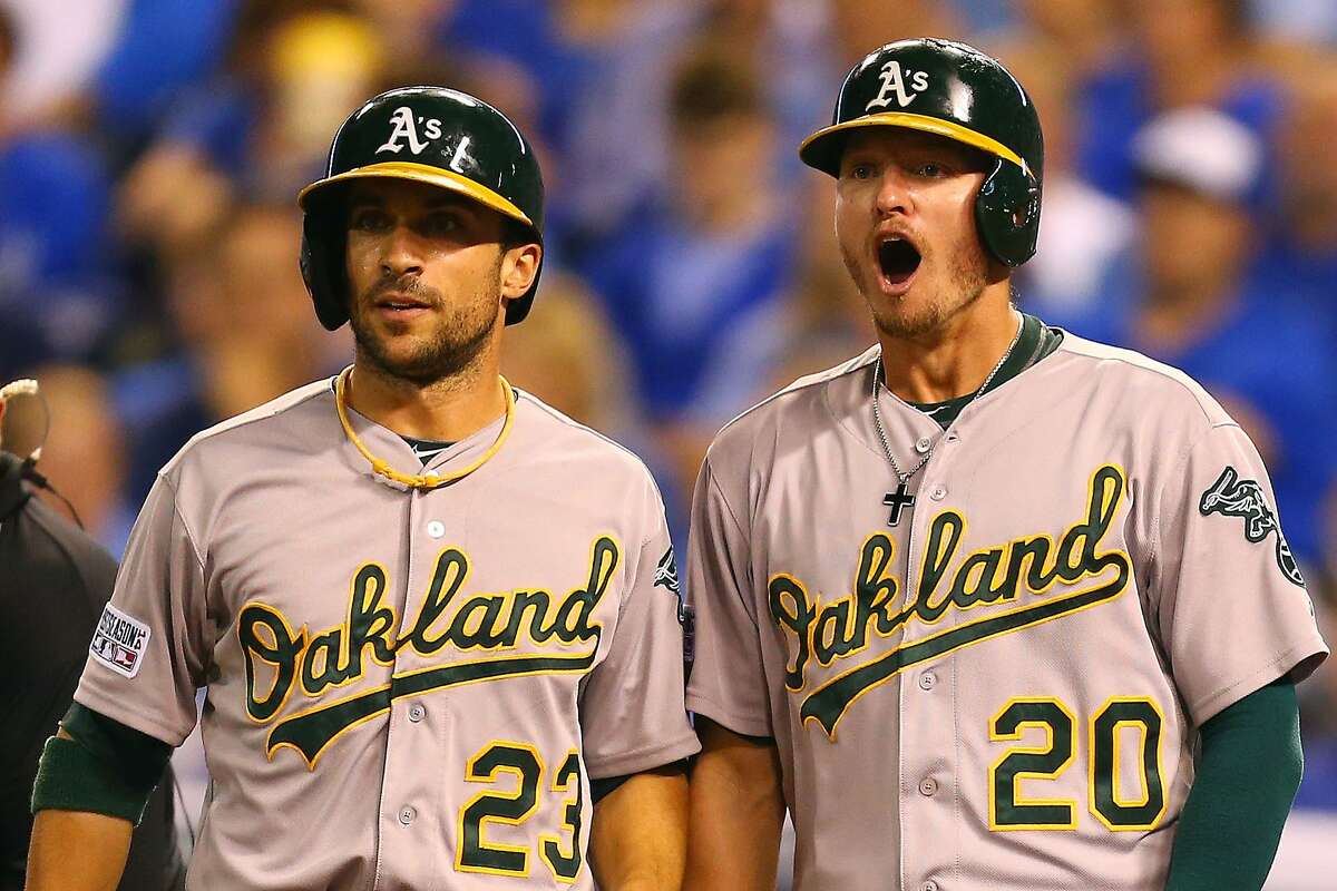 Josh Donaldson #20 and Sam Fuld #23 celebrate after Brandon Moss #37 of the Oakland Athletics hit a three-run home run in the sixth inning against the Kansas City Royals during the American League Wild Card game at Kauffman Stadium on September 30, 2014 in Kansas City, Missouri. (Photo by Dilip Vishwanat/Getty Images)
