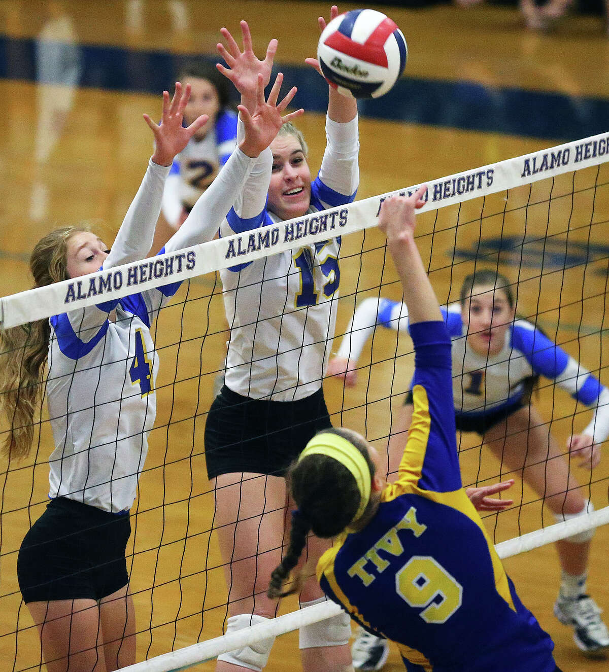 Lady Mules Taylor Whitlock (4) and McKay Kyle get up to block a shot by Kendall Bosse Alamo Heights hosts Tivy at the Alamo Heights Gym on September 30, 2014.