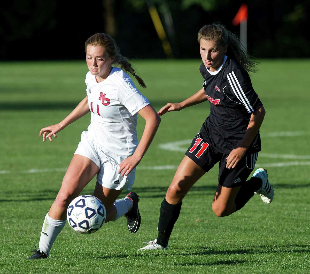 New Canaan's Kelly McClymonds, left, and Fairfield Warde's Hannah Allen, right, compete for control of the ball during a girls soccer game in New Canaan on Friday, Sept. 26.