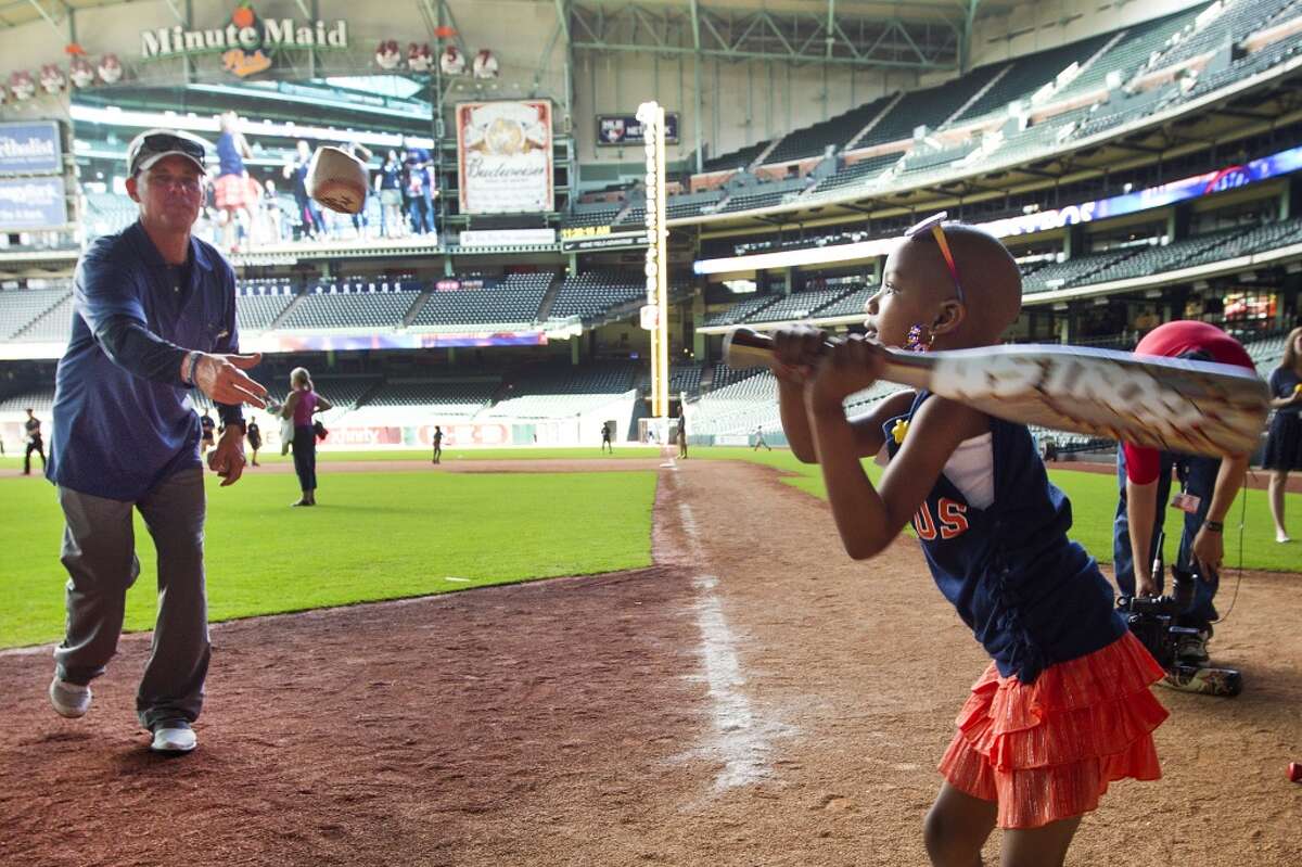 Craig Biggio pitches to Kyssi Andrews during Biggio's annual Sunshine Kids party at Minute Maid Park Wednesday, Oct. 1, 2014, in Houston. The children were given the ultimate Astros experience as they were able to step up to the plate to take pitches from Biggio, run the bases, and play in the outfield at Minute Maid Park. Afterwards, the kids ate lunch with Biggio and received autographs and goodie bags. ( Brett Coomer / Houston Chronicle )