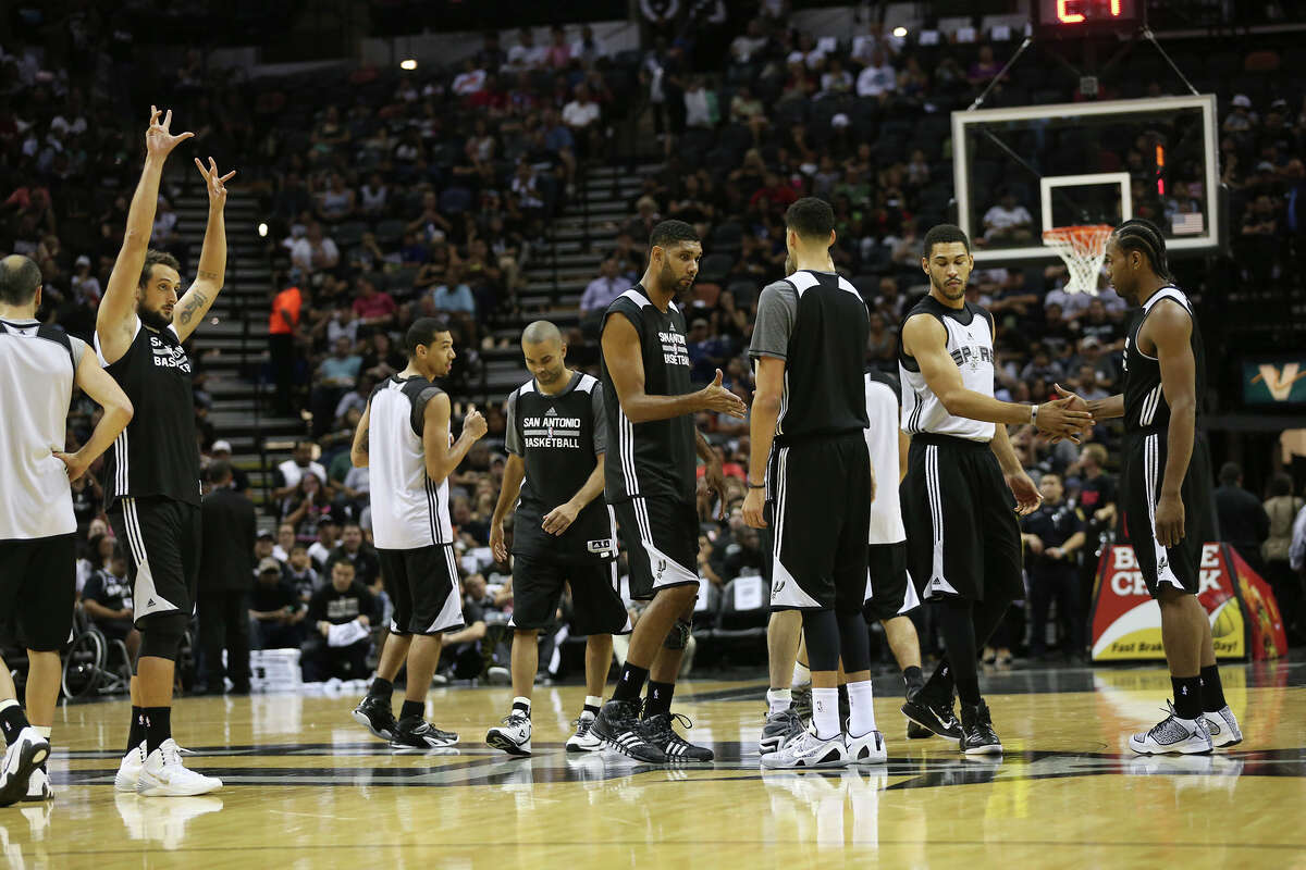 The San Antonio Spurs gather at midcourt for their public practice at the AT&T Center, Wednesday, Oct. 1, 2014.