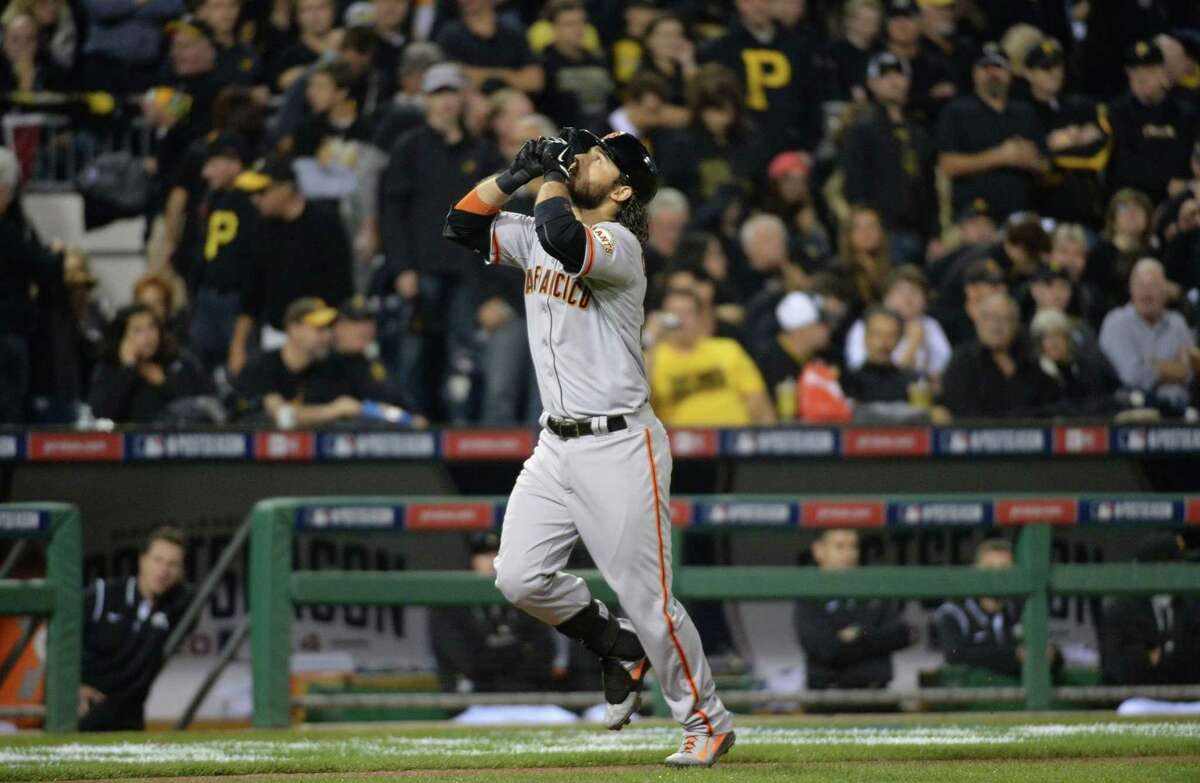 Brandon Crawford celebrates his grand slam in the fourth inning against the Pittsburgh Pirates in the National League Wild Card on Wednesday, Oct. 1, 2014, at PNC Park in Pittsburgh.