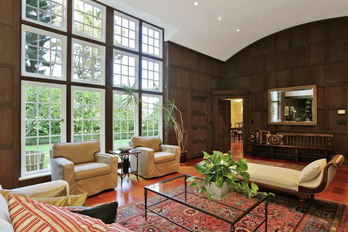 A wall of divided light windows makes the living room a warm and inviting space. 