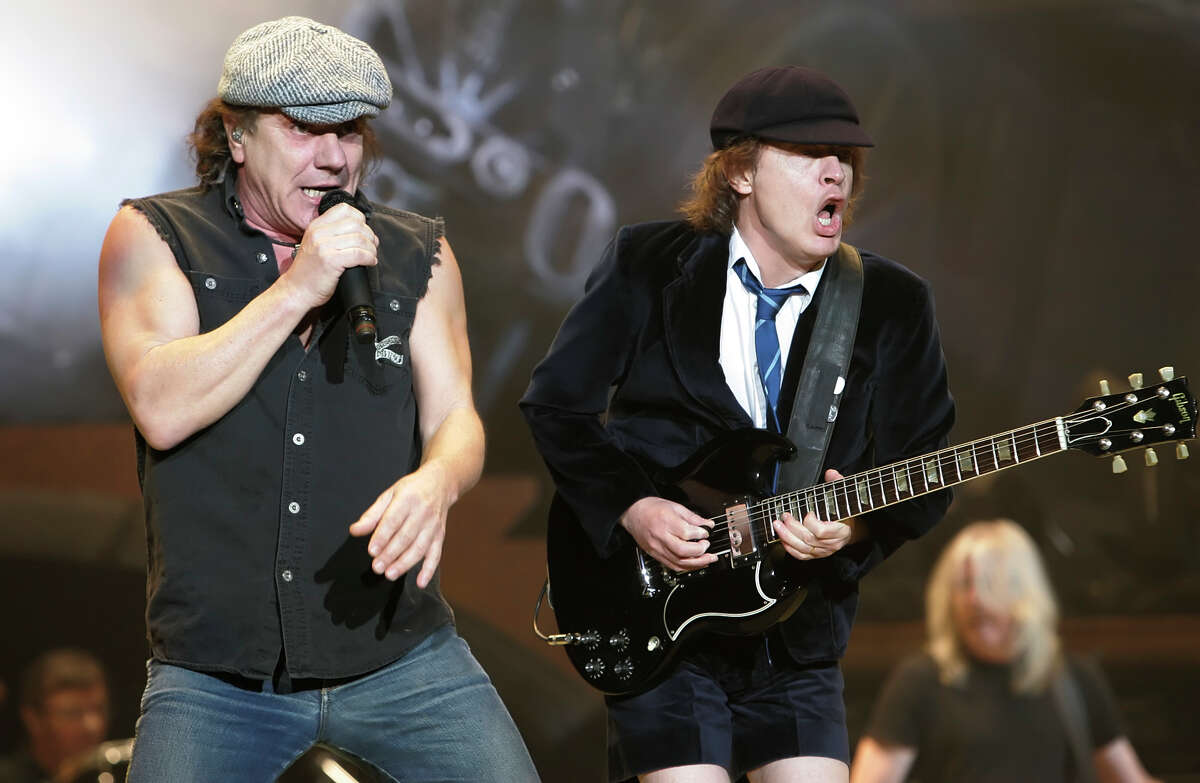 AC/DC lead singer Brian Johnson (left) and lead guitarist Angus Young perform to a packed audience at the AT&T Center on December 12, 2008. The show was reportedly sold out within 15 minutes. Kin Man Hui/kmhui@express-news.net