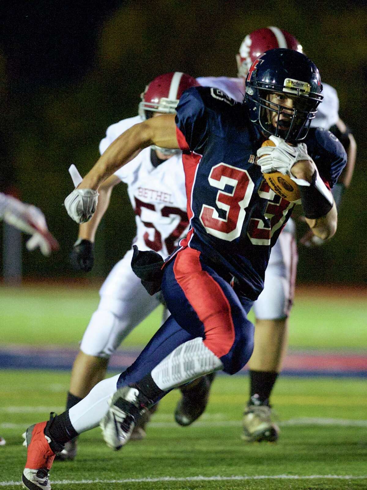 New Fairfield's Zachary Tripodi (33) runs with the ball during a football game between Bethel and New Fairfield High Schools , on Thursday, October 2, 2014, in New Fairfield, Conn.