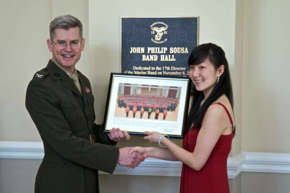 Catherine Chen stands with Col. Michael J. Colburn, conductor of the U.S .Marine Band, Saturday, after winning the annual Concerto Competition for the nation’s top high-school musicians in Washington, DC.