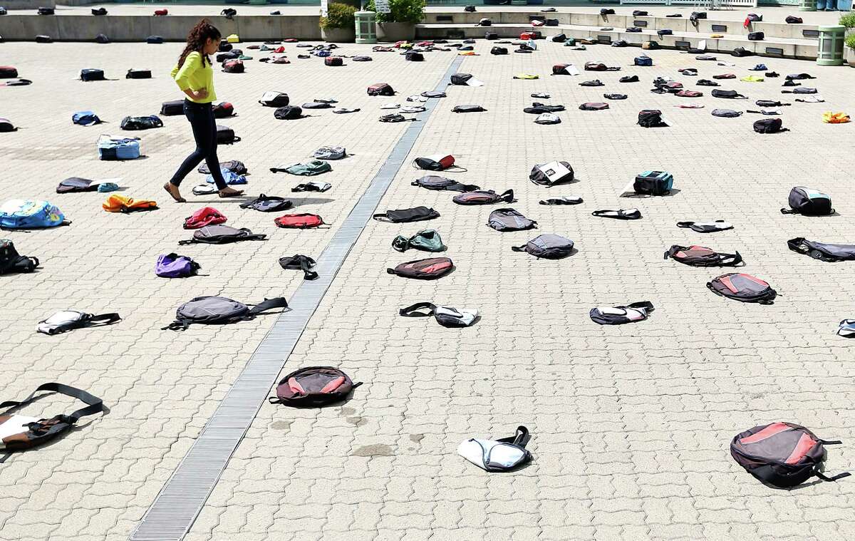 After spotting bags coving the ground of Jones Plaza, Alanna Murray walked over to see the 1,100 backpacks, many with personal stories, representing the estimated 1,100 college students who die by suicide each year at Thursday, Oct. 2, 2014, in Houston. "It's very sad and overwhelming," Murray said. "Seeing all these bags is like a symbol for whats going on." 