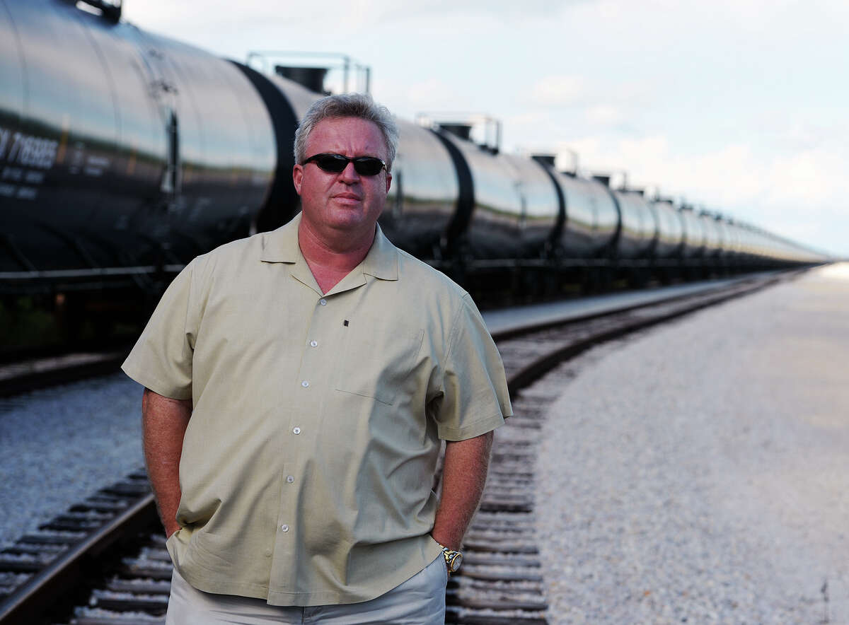Bart Owens, vice president and general manager of GT Logistics, stands next to a long line of empty train cars awaiting their next destination at the company's site in Port Arthur on Wednesday afternoon. GT Logistics at Omniport is in the business of transportation, specifically petrochemical products, but has the capacity to branch out into other materials. Photo taken Wednesday 10/1/14 Jake Daniels/@JakeD_in_SETX