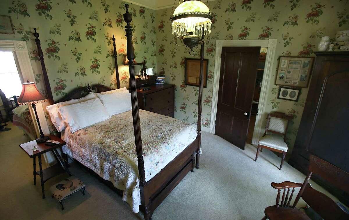 The four-poster bed in the front bedroom was made for Wayne Windle's grandmother, who is 100 years old. The trundle under the bed belonged to her great-grandmother.