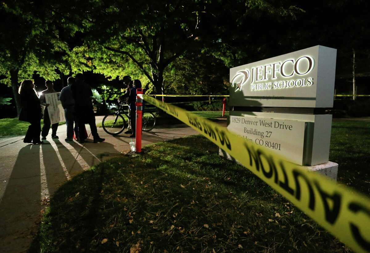Police tape blocks off the lawn in front of the Jefferson County Public Schools building, while inside the Jeffco Public School Board heard testimony from members of the public weighing in on the school board's proposal to emphasize patriotism and downplay civil unrest in the teaching of U.S. history, in Golden, Colo., Thursday, Oct. 2, 2014. Students and teachers fighting a plan to promote patriotism and downplay civil disobedience in some suburban Denver U.S. history courses packed a school board meeting Thursday where the controversial changes could face a vote. (AP Photo/Brennan Linsley)