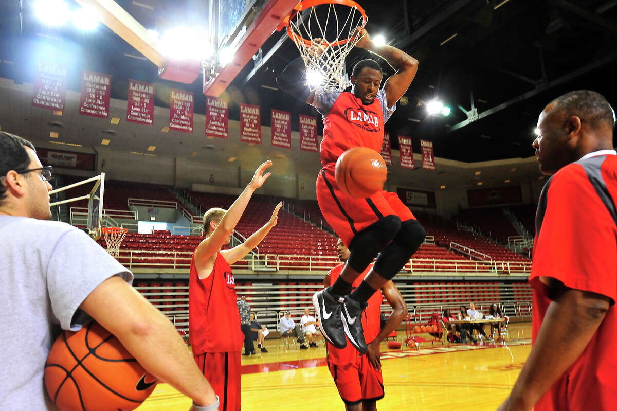 Lamar University's Donovan Ross dunks the ball after getting through the defensive pressure of teammates on the opening day of the men's basketball practice Friday in the Montagne Center. Photo taken Friday, October 3, 2014 Kim Brent/@kimbpix