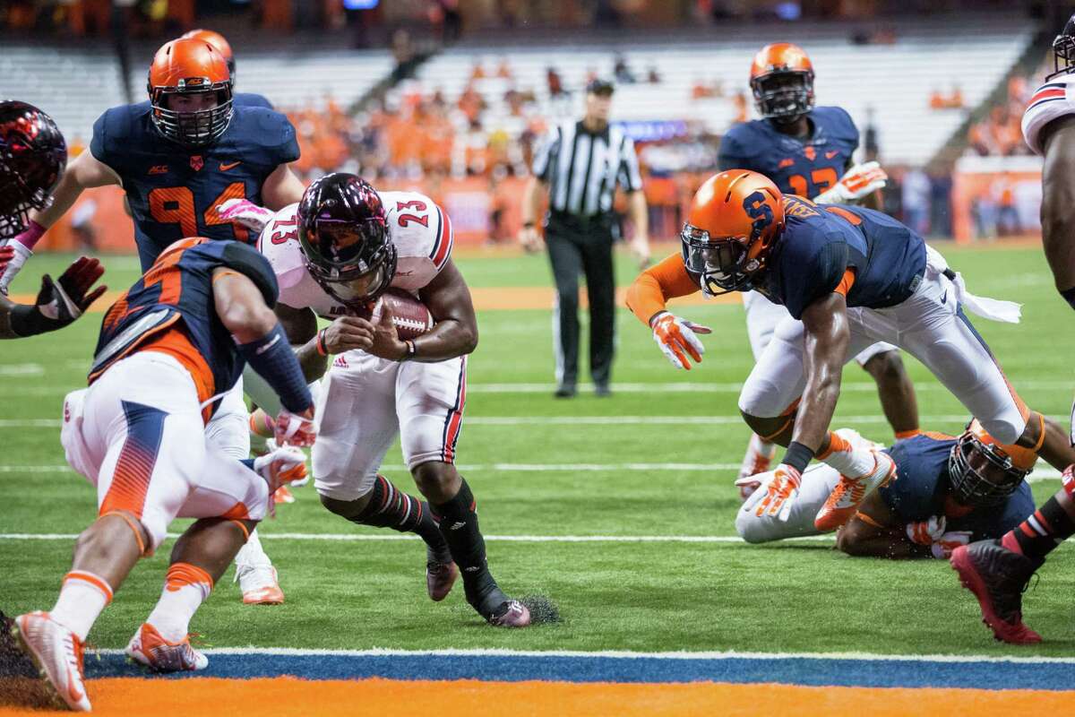 SYRACUSE, NY - OCTOBER 03: Brandon Radcliff #23 of the Louisville Cardinals scores a touchdown in the first quarter against the Syracuse Orange on October 3, 2014 at The Carrier Dome in Syracuse, New York. (Photo by Brett Carlsen/Getty Images) ORG XMIT: 515431853
