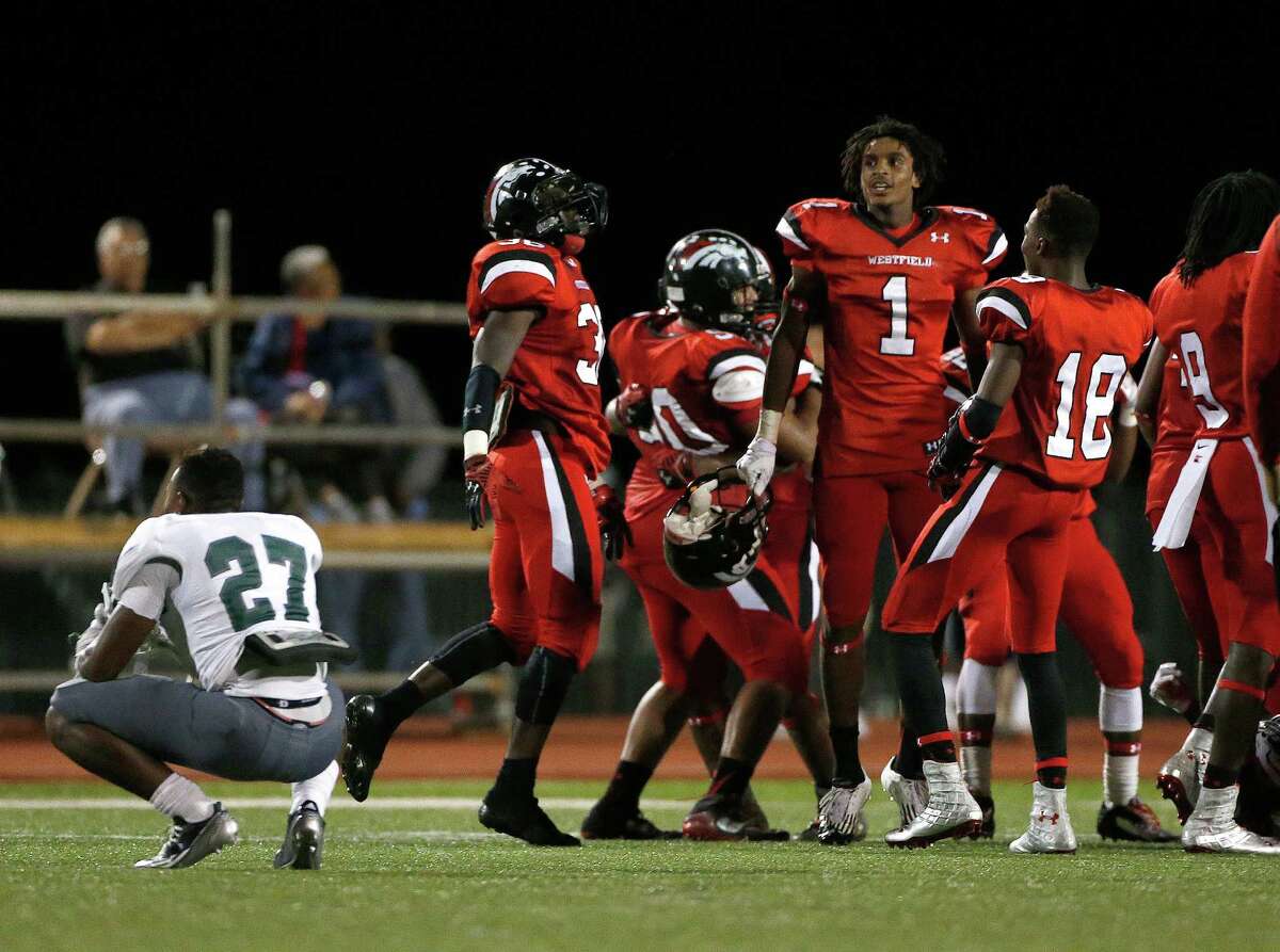 Spring's Olajuwon Pounds (27) dejects as the Westfield players celebrate their 38-37 win during the second half of a high school game at George Stadium, Friday, Oct. 3, 2014, in Spring.