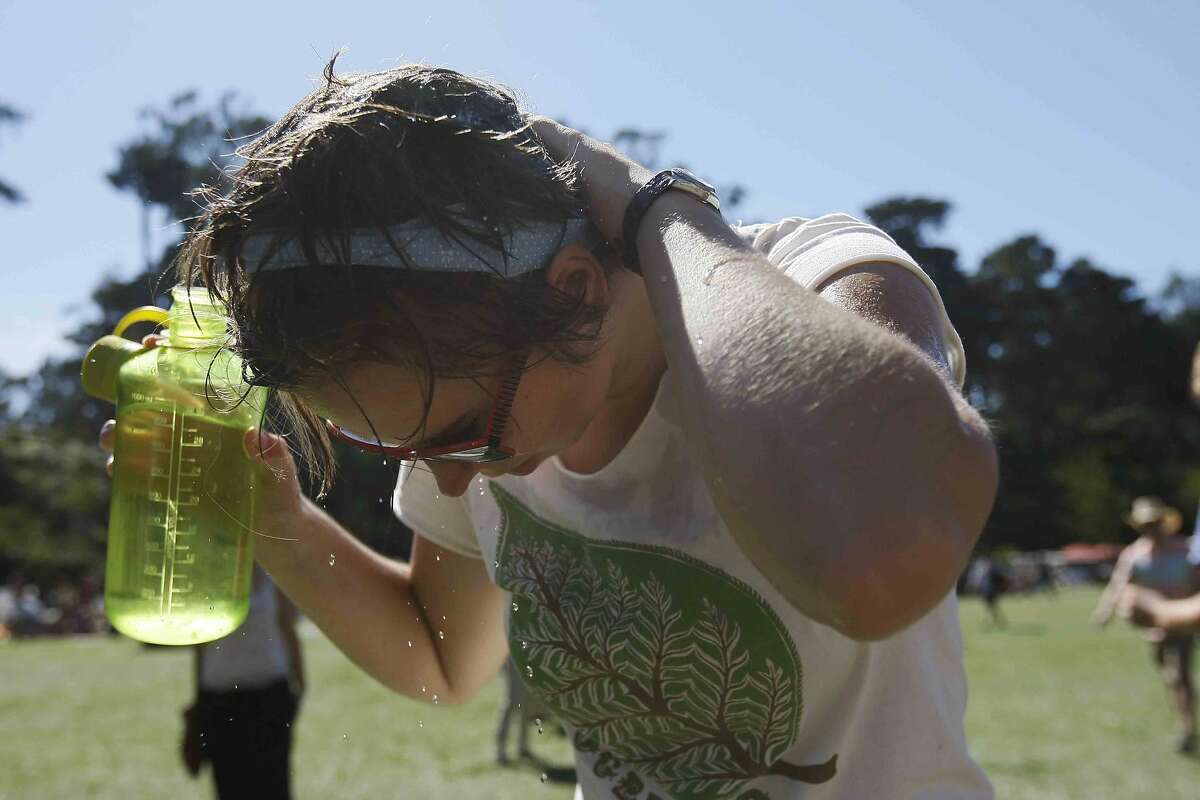Karen Eisenhauer of Claremont, Calif. cools off during the second day of the Hardly Strictly Bluegrass Festival in San Francisco's Golden Gate Park Saturday, October 4, 2014.