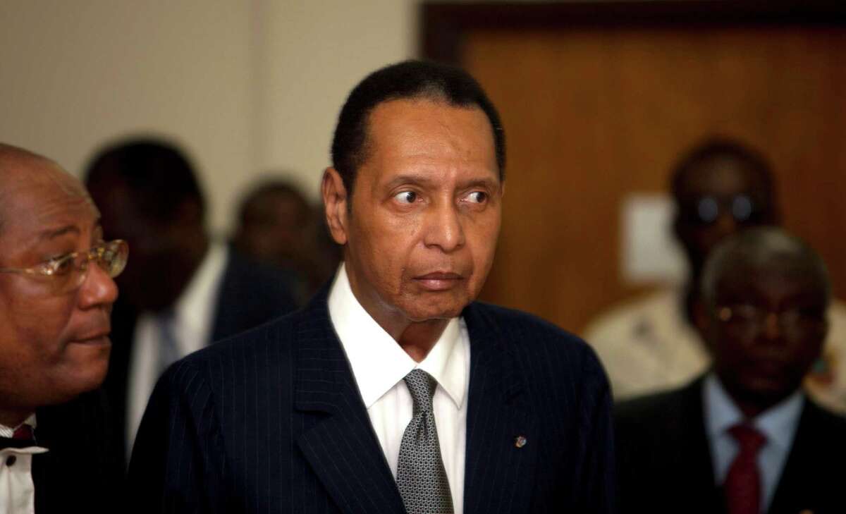 FILE - In this Feb. 28, 2013 file photo, former Haitian dictator Jean-Claude Duvalier, known as "Baby Doc," attends his hearing at court in Port-au-Prince, Haiti. Duvalier, the self-proclaimed "president for life" of Haiti whose corrupt and brutal regime sparked a popular uprising that sent him into a 25-year exile, died Saturday, Oct. 4, 2014 of a heart attack, his attorney said. He was 63. (AP Photo/Dieu Nalio Chery, File) ORG XMIT: NY115