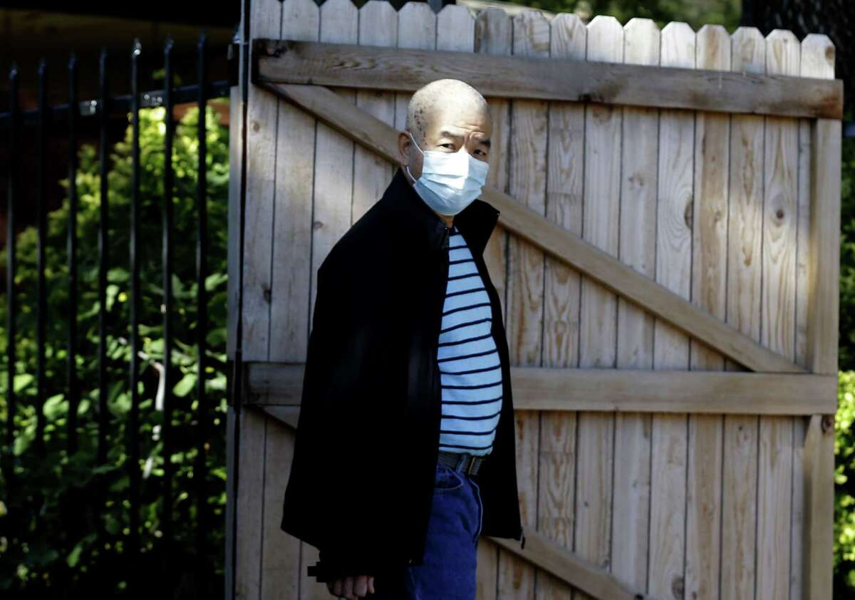 A man displays his concern Saturday, wearing a mask as he walks back from taking out garbage near an apartment complex where Thomas Eric Duncan, the Ebola patient who traveled from Liberia to Dallas, stayed last week.﻿