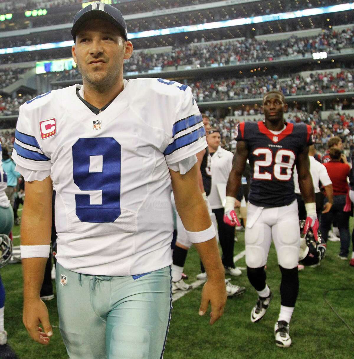 Dallas Cowboys quarterback Tony Romo (9) walks off the field after the Cowboys overtime win over the Houston Texans during an NFL football game at AT&T Stadium, Sunday, Oct. 5, 2014, in Arlington.
