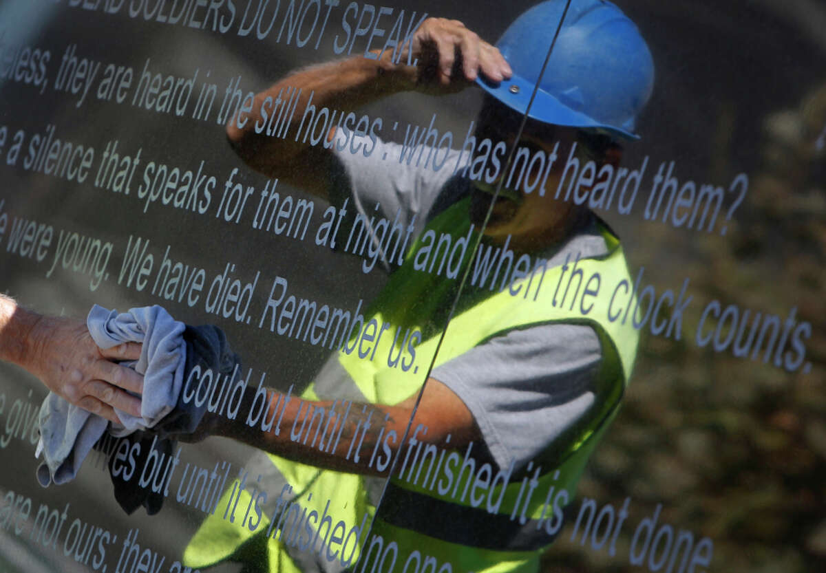 Montgomery polishes the freshly engraved inscription on the Veterans Memorial at the complex at S.F.’s Civic Center.