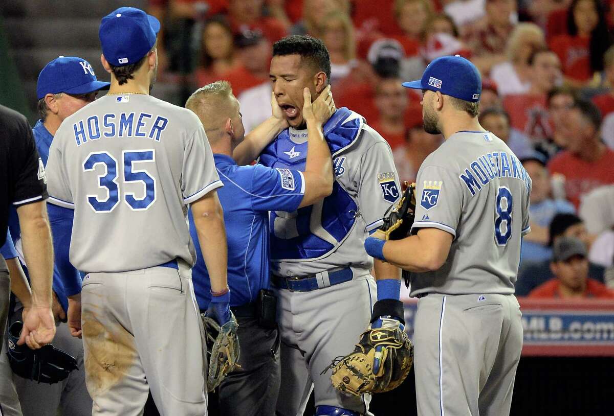 ANAHEIM, CA - OCTOBER 03: Salvador Perez #13 of the Kansas City Royals receives medical attention after being hit in the head by a bat in the fifth inning against the Los Angeles Angels during Game Two of the American League Division Series at Angel Stadium of Anaheim on October 3, 2014 in Anaheim, California. (Photo by Harry How/Getty Images)
