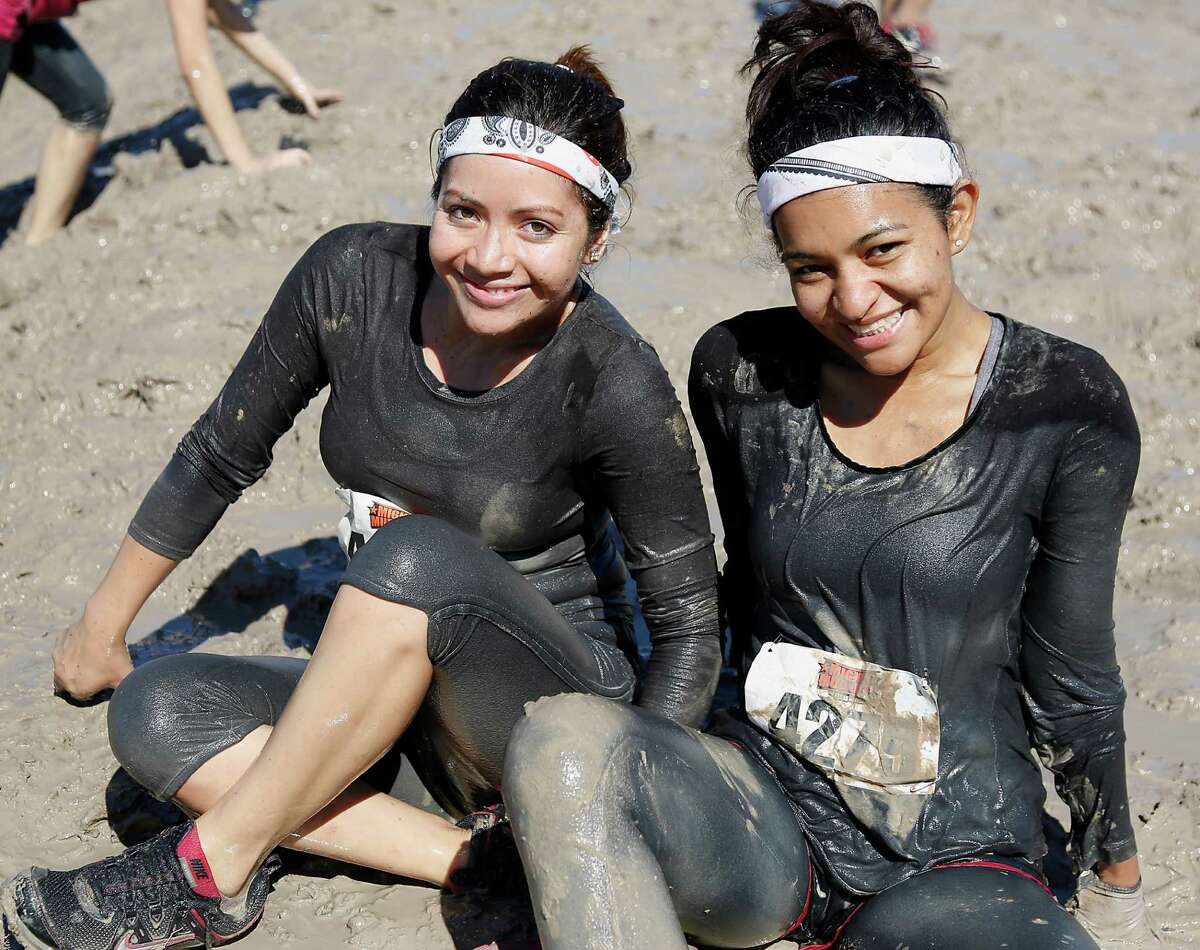 Dashers pose for a photograph during the MIGHTY MUD DASH 5k challenge Sunday, Oct. 5, 2014, in Houston. The dash has 20+ Military style obstacles.
