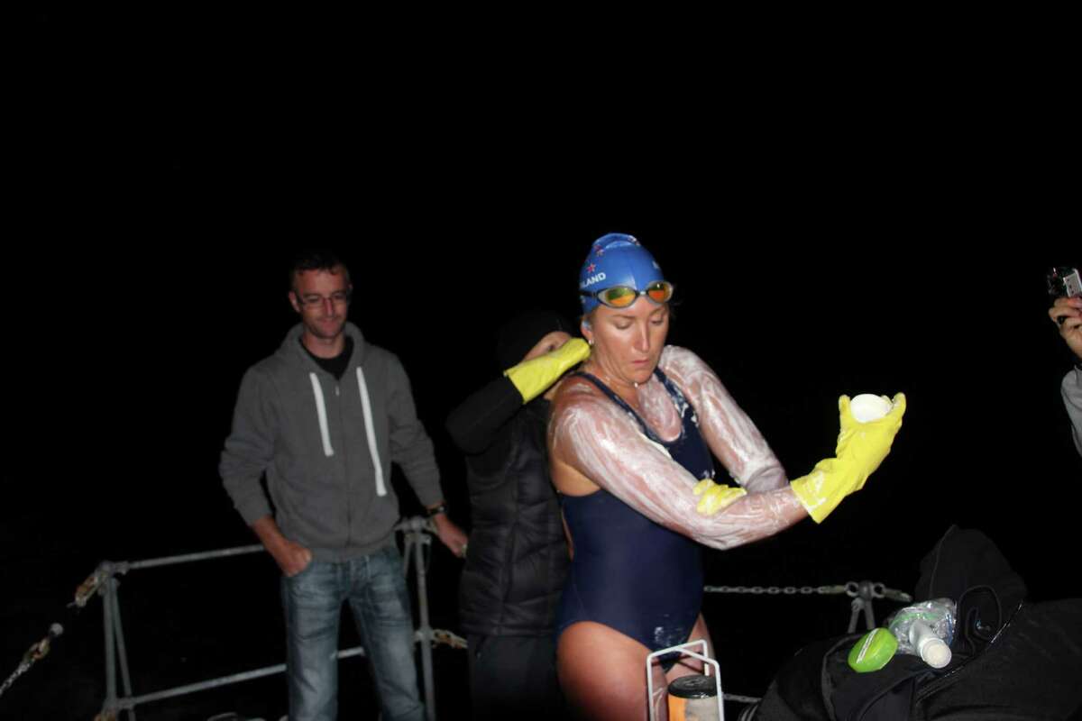 Kim Chambers slathers on jellyfish repellent and lanolin during her swam across the North Channel from northern Ireland to Scotland, on Sept. 2, 2014. It took her 13 hours and 6 mins in 14 degree Celsius water.