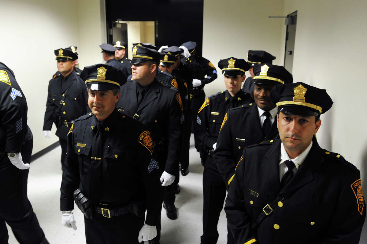 Bridgeport Police officers line up to enter a prom0tional ceremony in Bridgeport, Conn. Sept. 4, 2014.