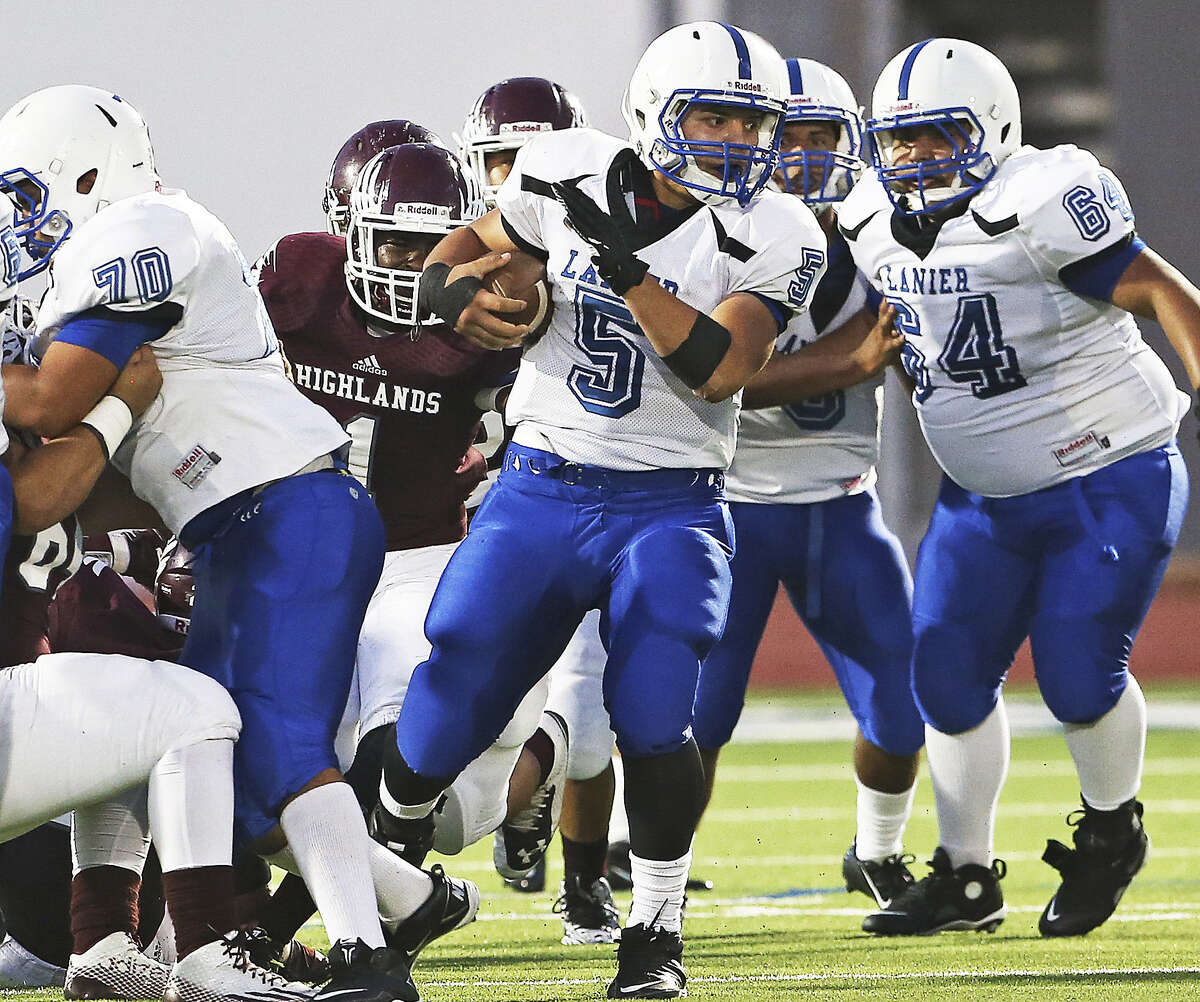 Vok running back Joe Orta takes advantage of a hole created by big men Jose Gamon (70) and Christopher Orozco as Highlands plays Lanier at Alamo Stadium on Oct. 2.