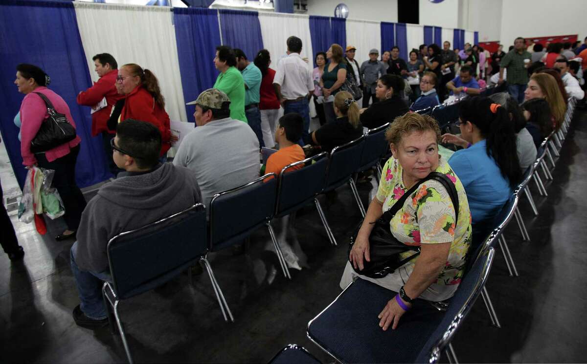 Marian Salegio, 54, has no insurance and waits in line to enroll for healthcare during the Affordable Care Act town hall meeting at George R. Brown Convention Center on Saturday, Nov. 16, 2013, in Houston. ( Mayra Beltran / Houston Chronicle )
