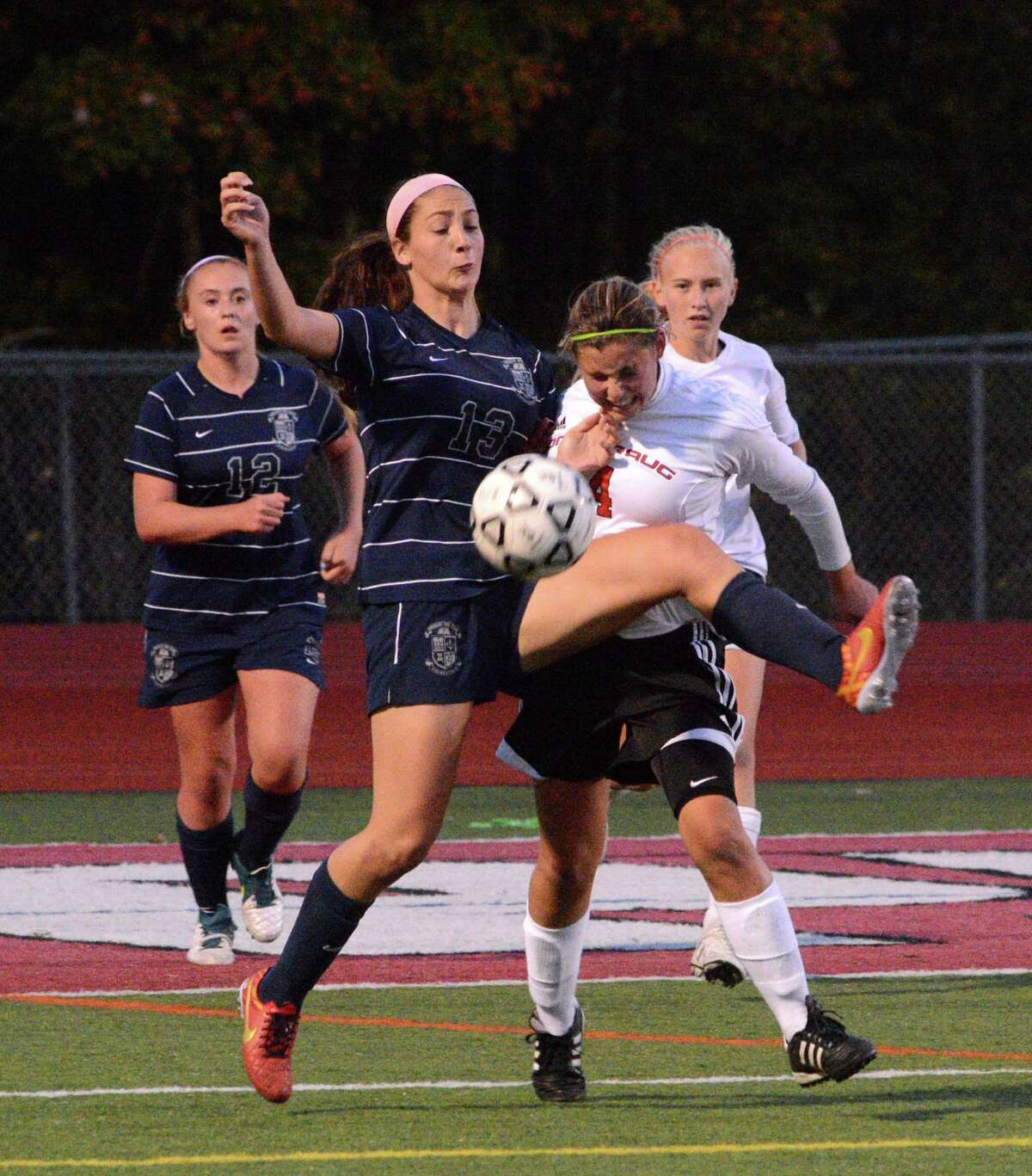 Immaculate High Schools Paige Davis fights for possession of the ball against Pomperaug High Schools Lauren Piro during a game at Pomperaug on Monday, October 6, 2014.