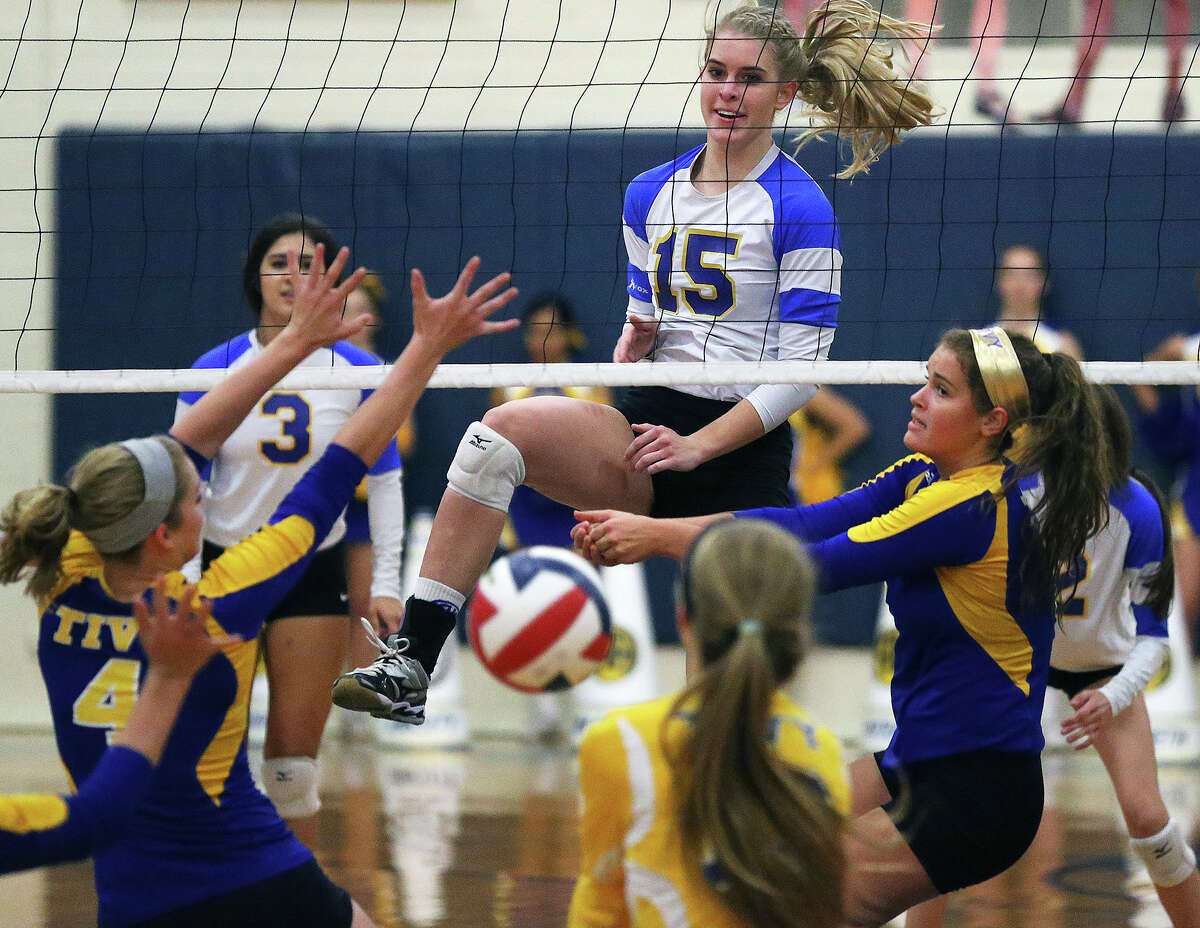 Lady Mule McKay Kyle enjoys the scramble on the other side of the net after her shot as Alamo Heights hosts Tivy at the Alamo Heights Gym on September 30, 2014.