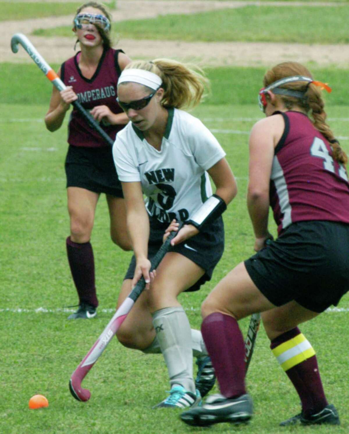 Brittney Dubret of the Green Wave gains possession during New Milford High School field hockey's 2-1 victory over Pomperaug, Sept. 16, 2014 at NMHS.
