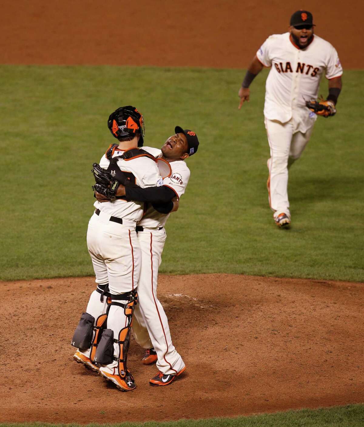 Catcher Buster Posey is lifted by closing pitcher Santiago Casilla after the San Francisco Giants beat the Washington Nationals 3-2 in game four of the National League Division Series at AT&T Park in San Francisco , Calif., on Tuesday Oct. 7, 2014.