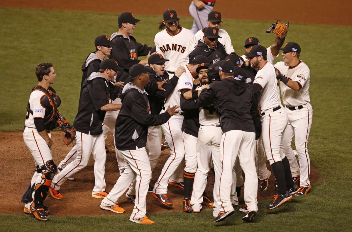 The San Francisco Giants celebrate after beating the Washington Nationals 3-2 in game four of the National League Division Series at AT&T Park in San Francisco , Calif., on Tuesday Oct. 7, 2014.
