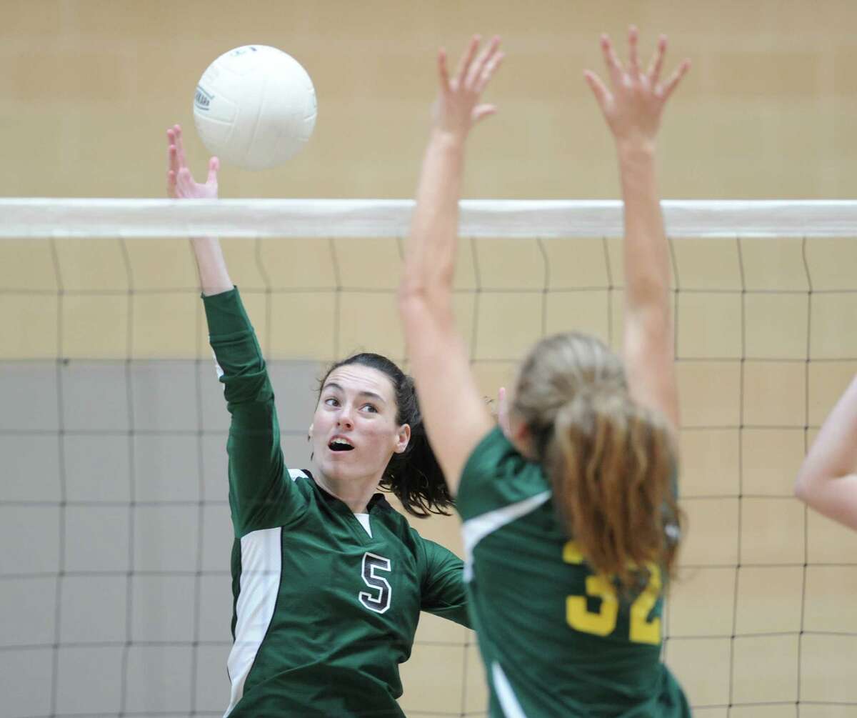 At left, Convent's Claire O'Neill (#5) gets her shot past Greenwich Academy's Clare Ryan (#32) during the girls high school volleyball match between Convent of the Sacred Heart and Greenwich Academy at Brunswick School in Greenwich, Conn., Wednesday, Oct. 8, 2014. Convent of the Sacred Heart defeated Greenwich Academy, 3-0.