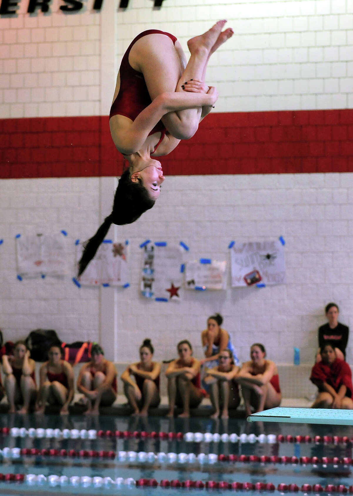 Fairfield Warde's Tess Shinbaum does a flip as she dives, during swim meet action against Fairfield Ludlowe at Fairfield University in Fairfield, Conn. on Wednesday October 8, 2014.