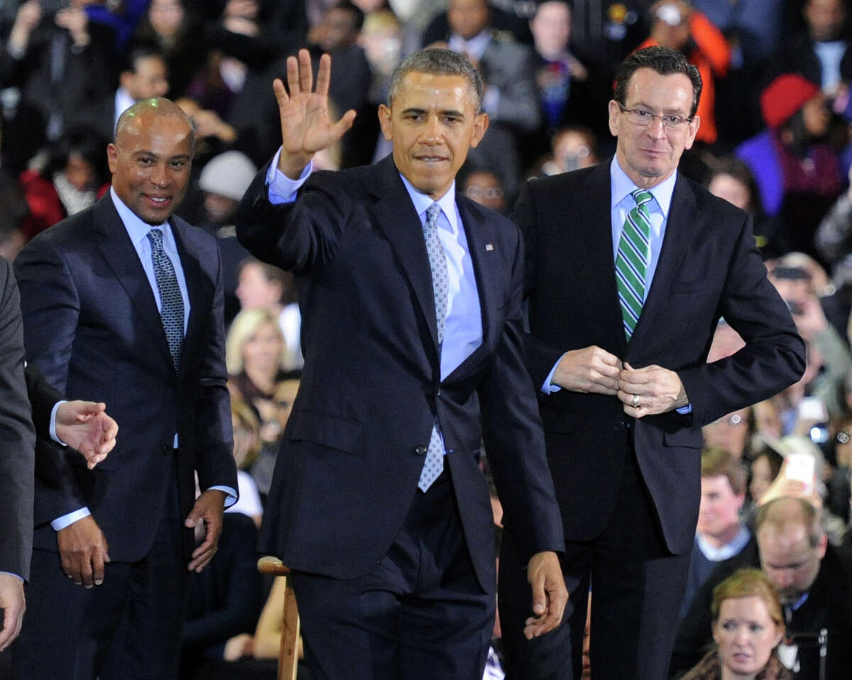 President Barack Obama waves to the crowd, joined by Massachusetts Governor Deval Patrick, left, and Connecticut Governor Dannel P. Malloy, right, after speaking at Kaiser Hall Gymnasium on the campus of Central Connecticut State University in New Britain, Conn. Wednesday, March 5, 2014. The President is expected to be in Bridgeport, Conn. on Wednesday Oct 15, 2014.