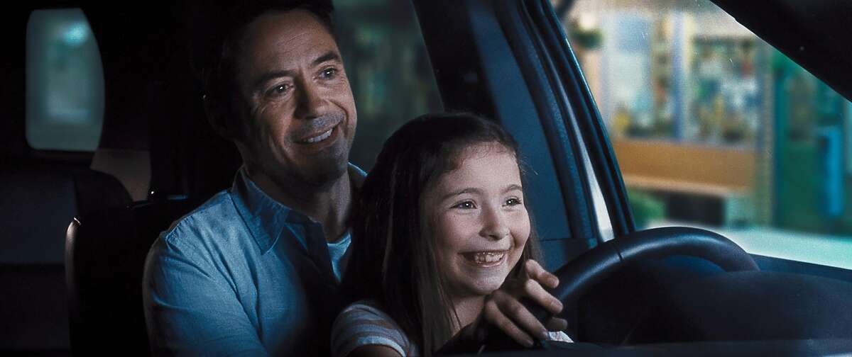 This photo released by Warner Bros. Pictures shows, Robert Downey Jr., left, as Hank Palmer and Emma Tremblay as Lauren Palmer in Warner Bros. Pictures' and Village Roadshow Pictures' drama "The Judge" a Warner Bros. Pictures release. The movie releases in the U.S. on Friday, Oct. 10, 2014. (AP Photo/Warner Bros. Pictures)