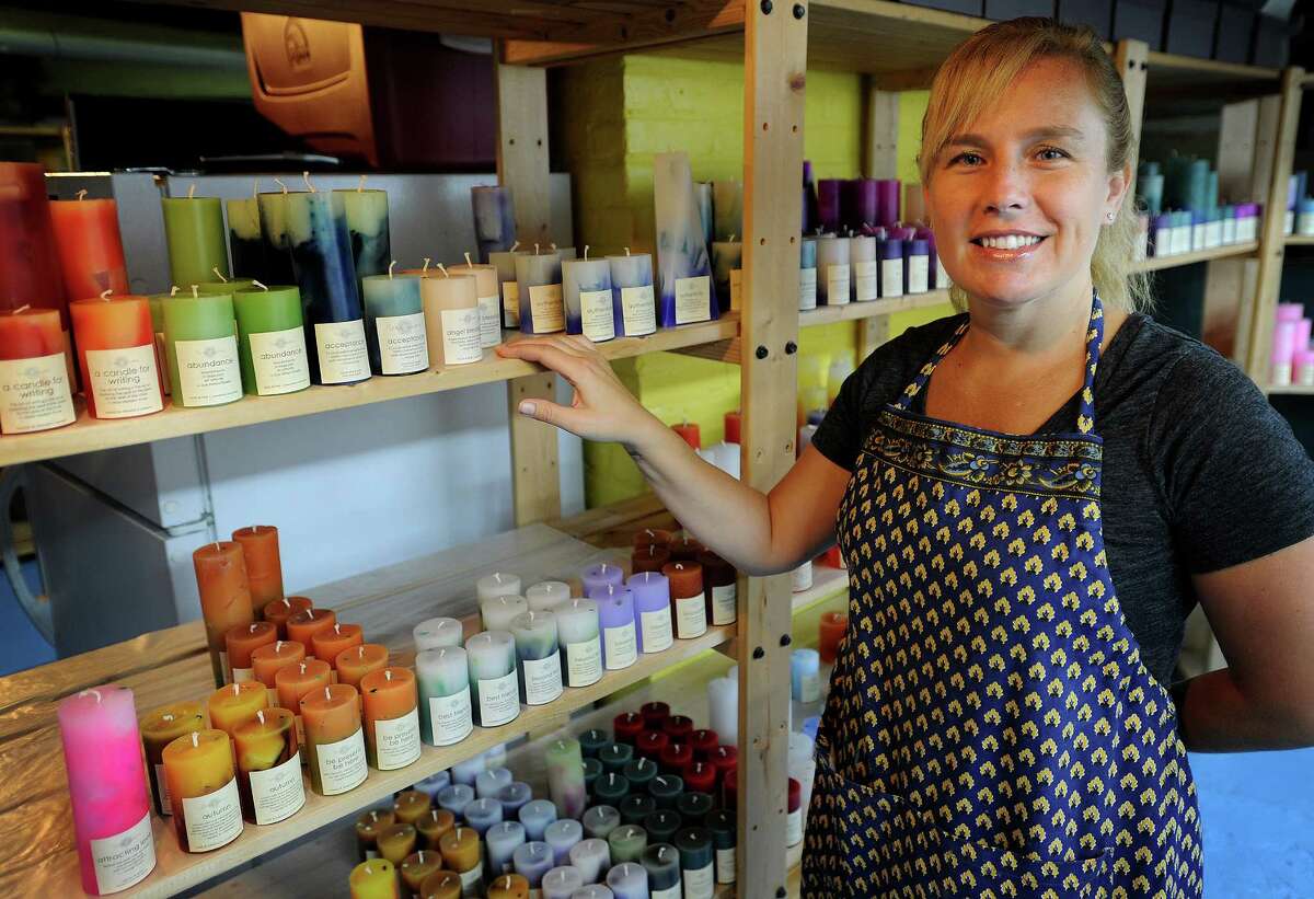 Jenn Heatly, owner of Zena Moon, makes scented candles in the basement of her Norwalk home. Heatly purchased the business, which originated in Spokane, WA, in July of this year.