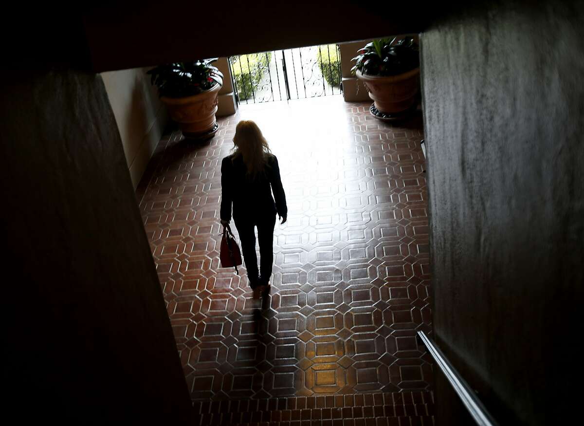 Pamela Kelley walks through the lobby area of a flat she has rented out for 30 days Tuesday October 7, 2014. Pamela Kelley operates a short term rental company in San Francisco, Calif. Recent Airbnb legislation cuts into her business, much of which used to come from VRBO/HomeAway.