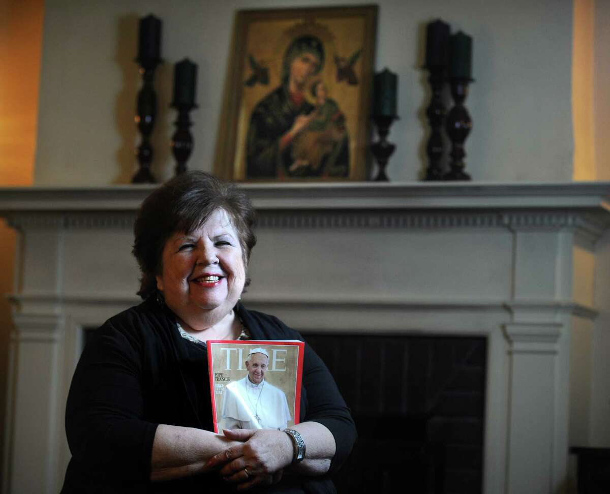 Bette Huckabee holds an issue of Time magazine featuring Pope Francis on the cover at her home in Bridgeport, Conn. Huckabee runs Hearts Renewed, a support group for divorced Catholics which meets at St. Pius Church in Fairfield, Conn. She was excited to read about Pope Francis presiding over the wedding of 20 couples in St. PeterâÄôs Basilica, some of whom were previously married and news that he has called for "a season of mercy" on the Church's ban on divorced and remarried Catholics receiving Communion.
