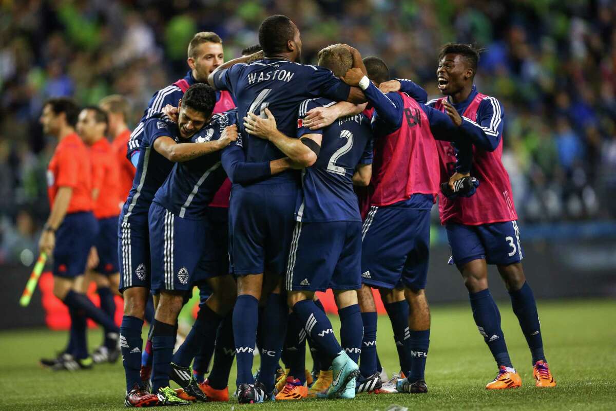 Vancouver Whitecaps players celebrate after defeating the Seattle Sounders on Friday, October 10, 2014. The Whitecaps won the Cascadia Cup after beating the Sounders 1-0.