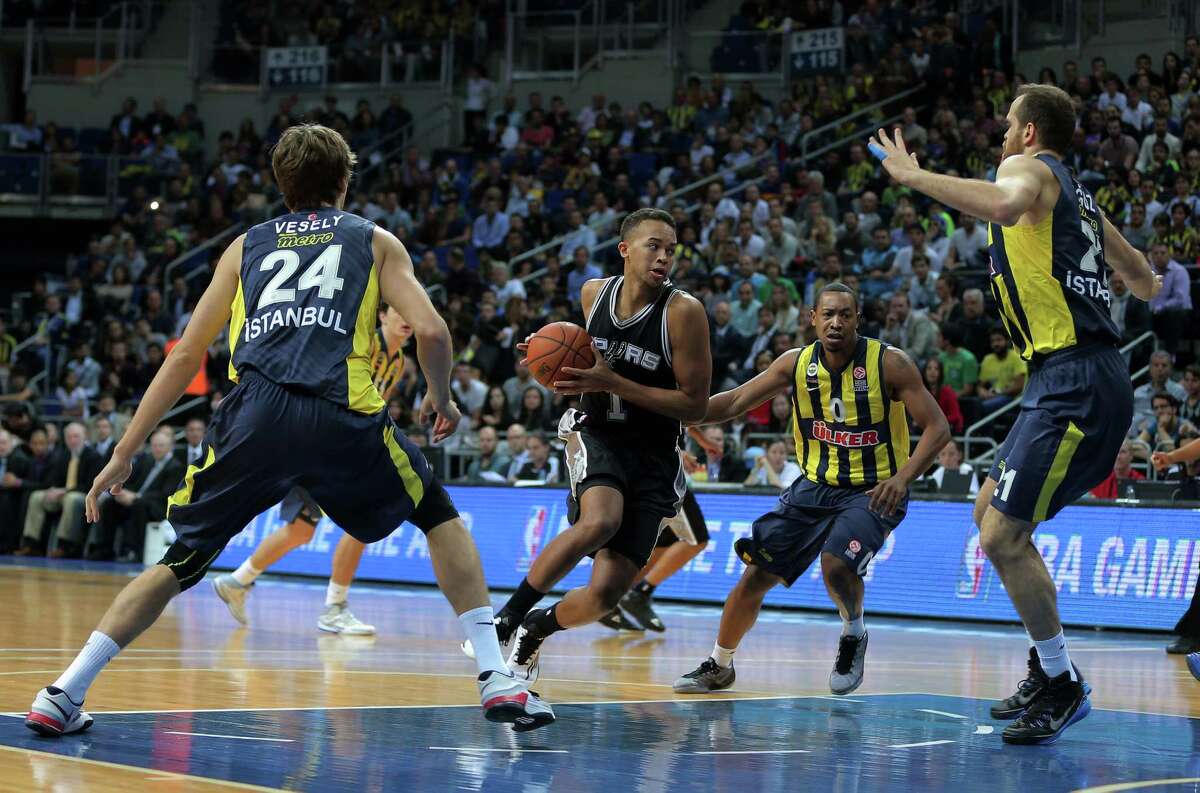 San Antonio Spurs' Kyle Anderson, second left, controls the ball against Fenerbahce Ulker's Jan Vesely, left, Oguz Savas, right, and Andrew Goudelock during an NBA Global Games basketball match between US team San Antonio Spurs and Turkey's Fenerbahce Ulker, in Istanbul, Turkey, Saturday, Oct. 11, 2014.