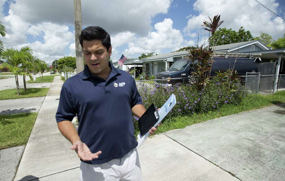 In this Aug. 12, 2014 photo, Andres Malave walks the street of a west Miami neighborhood. He started the day huddled with about a dozen volunteers in a Cuban restaurant here, offering them a last-minute pep talk before they went out to meet with voters. Itâs a strategy playing out in New England diners, Midwest truck stops and West Coast cafes: coordinators for Americans for Prosperity conservative organizers train and dispatch send out hundreds thousands of volunteers armed with an iPad and an interest in helping fellow activists shift Americaâs politics in their direction. These volunteers ground troops make up the backbone of Americans for Prosperity, the flagship organization of the political network overseen by industrialist billionaires Charles G. and David H. Koch. (AP Photo/J Pat Carter)