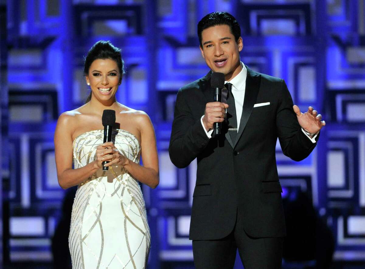 Hosts Eva Longoria, left, and Mario Lopez speak on stage at the NCLR ALMA Awards at the Pasadena Civic Auditorium on Friday, Oct. 10, 2014, in Pasadena, Calif. (Photo by Chris Pizzello/Invision/AP)